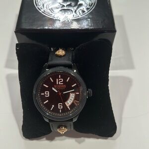 Versace Versus watch with lion head accent on strap.